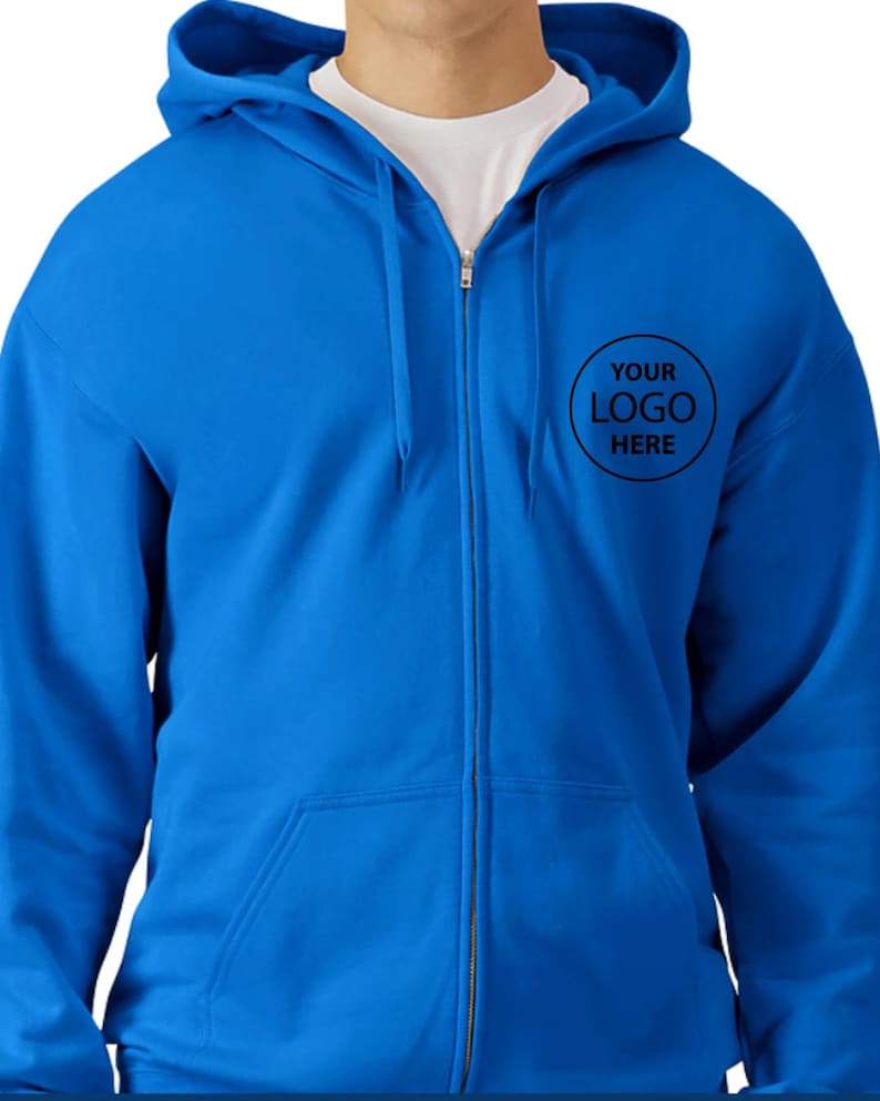 A man wearing a blue hooded sweatshirt with a logo on the front.