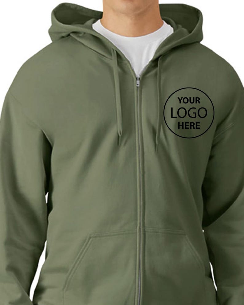 A man wearing a green zip-up hoodie with a logo on the front.