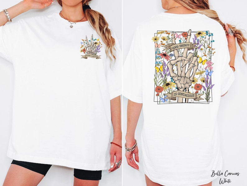A white t-shirt with a graphic design on the back, featuring a skeleton hand holding a flower and the text "It's Contagious" along with a banner.