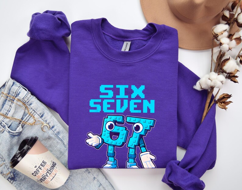 a purple long-sleeved shirt with a graphic design, a pair of jeans, a hat, and some cotton flowers.