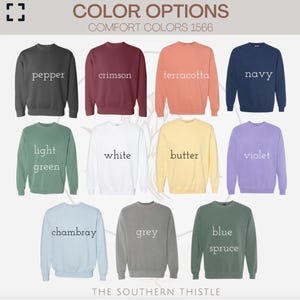 a collection of 12 different colored sweatshirts, each with a unique color and design. The sweatshirts are arranged in a grid format, with three rows and four columns. The text "COLOR OPTIONS" is visible at the top of the image, and "COMFORT COLORS 1566" is written below it. The text "THE SOUTHERN THISTLE" is at the bottom of the image.