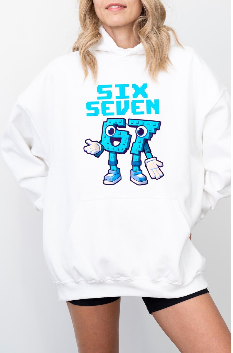 A white hoodie with a graphic design featuring a character that says "Six Seven" in blue and teal colors.