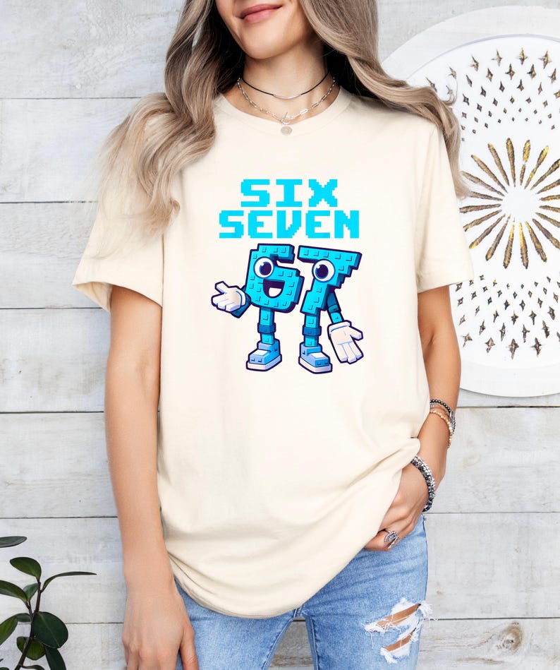 A woman wearing a white t-shirt with a graphic design of a blue character that says "Six Seven" and a number "67" on it.