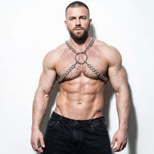 Men's silver chain chest harness, front view, muscular model, lightweight aluminum O-ring body jewelry, gay pride festival accessory