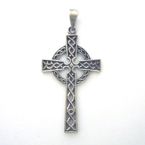 May include: A silver Celtic cross pendant with intricate knotwork design.