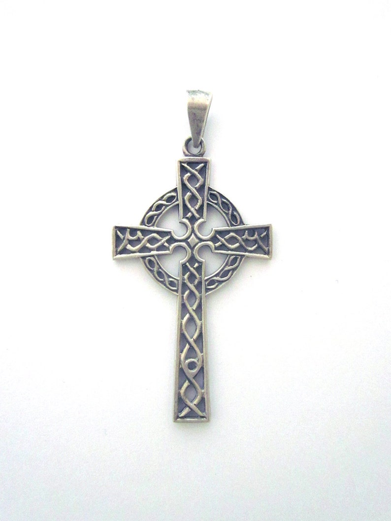 May include: A silver Celtic cross pendant with intricate knotwork design.