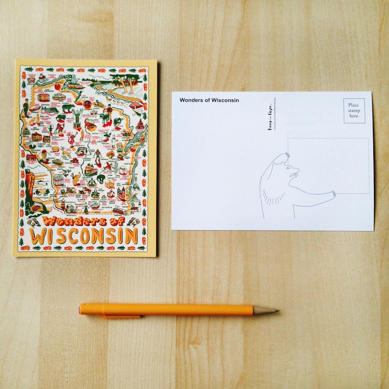 May include: A postcard with a map of Wisconsin and the words "Wonders of Wisconsin" in orange. The back of the postcard has a bear illustration and the words "Wonders of Wisconsin". An orange pen is also in the image.