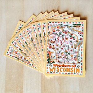 May include: A stack of postcards with a map of Wisconsin, featuring illustrations of landmarks and attractions. The postcards have a yellow background with a decorative border and the words "Wonders of Wisconsin" in orange and white.