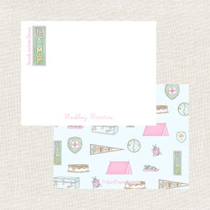 May include: Stationery set featuring a white notepad with the name "Hadley Harris" in pink script. The notepad has a green and pink "CAMP" design. The patterned backing paper has a light blue background with camping-themed illustrations.
