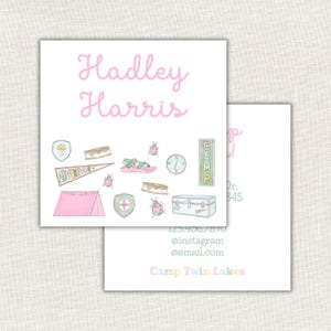 May include: Two white cards with a pink watercolor design. The top card has the name "Hadley Harris" in pink script. The bottom of the card has illustrations of camping items. The second card has contact information and the words "Camp Twin Lakes".