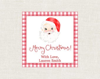 Può includere: Biglietto di Natale quadrato con un'illustrazione ad acquerello di Babbo Natale, con cappello rosso e barba bianca. Il biglietto ha un bordo a quadretti rossi e bianchi e le parole "Merry Christmas!" e "With Love, Lauren Smith".