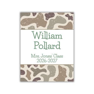 May include: A rectangular label featuring a camouflage pattern in shades of brown, tan, and dark grey at the top and bottom. The centre white section displays the text William Pollard, Mrs. Jones' Class, and 2026-2027 in a dark green font.