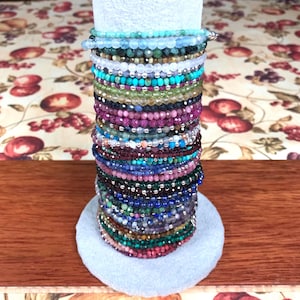 May include: A set of three ceramic mugs with a speckled, matte finish. The mugs are in shades of cream, light gray, and dark gray. Each mug has a simple, minimalist design, perfect for coffee or tea.