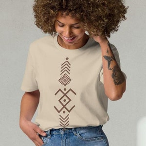 May include: A beige t-shirt with a brown geometric design on the front. The design features a series of triangles, squares, and circles.