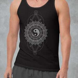 May include: Black vest top with a grey Yin Yang mandala design. The intricate design is centered on the front, surrounded by geometric shapes. The vest top is sleeveless and made of a soft material.