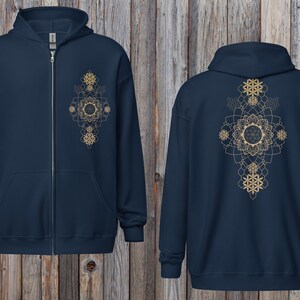 May include: A navy blue zip-up hoodie with a gold geometric mandala design on the front and back. The hoodie has a hood, a full-length zipper, and two front pockets. The design is symmetrical and features intricate patterns.