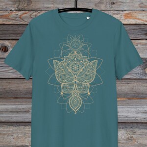 May include: A teal blue t-shirt with a gold mandala design featuring a butterfly and geometric patterns.