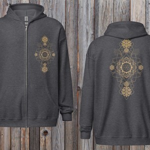 May include: Charcoal gray zip-up hoodie with a gold geometric mandala design on the front and back. The hoodie has a hood, a full-length zipper, and two front pockets. The design features intricate patterns.