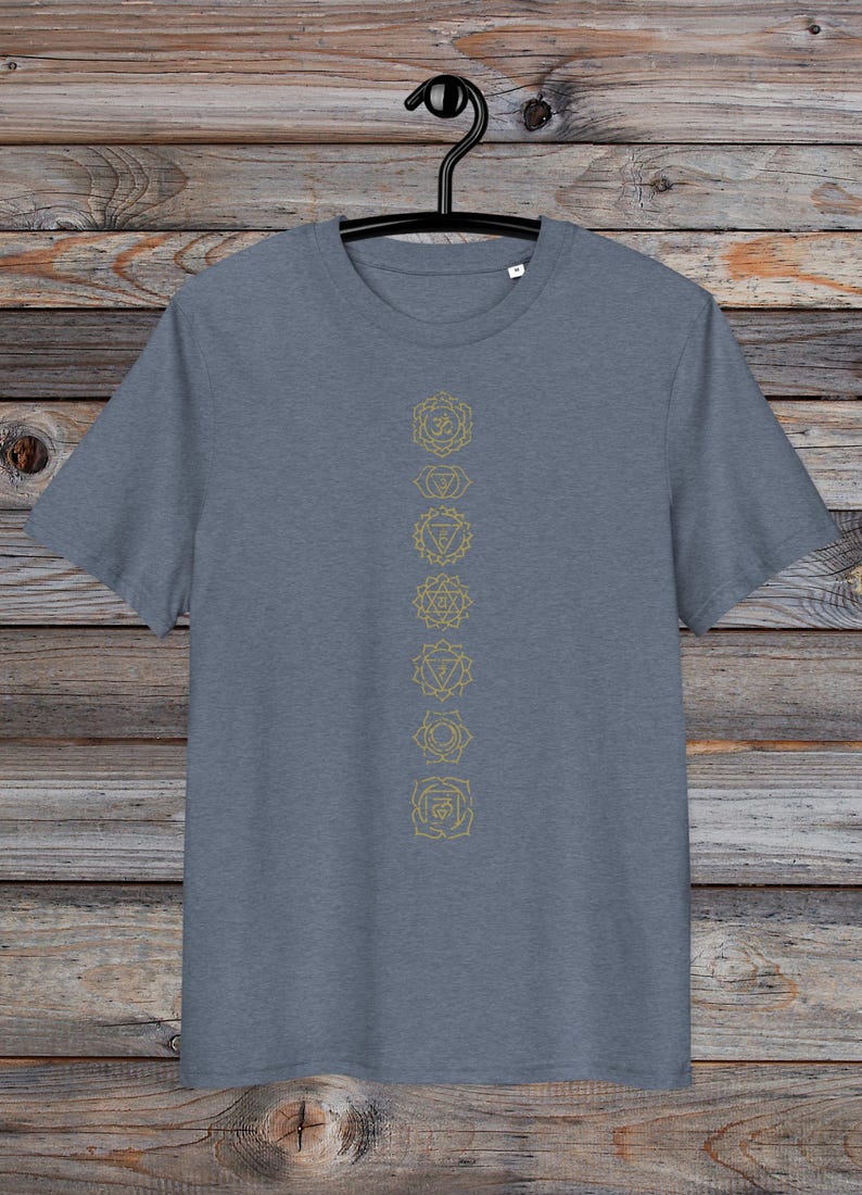 May include: A heather grey t-shirt with a vertical row of seven gold chakra symbols printed on the front.