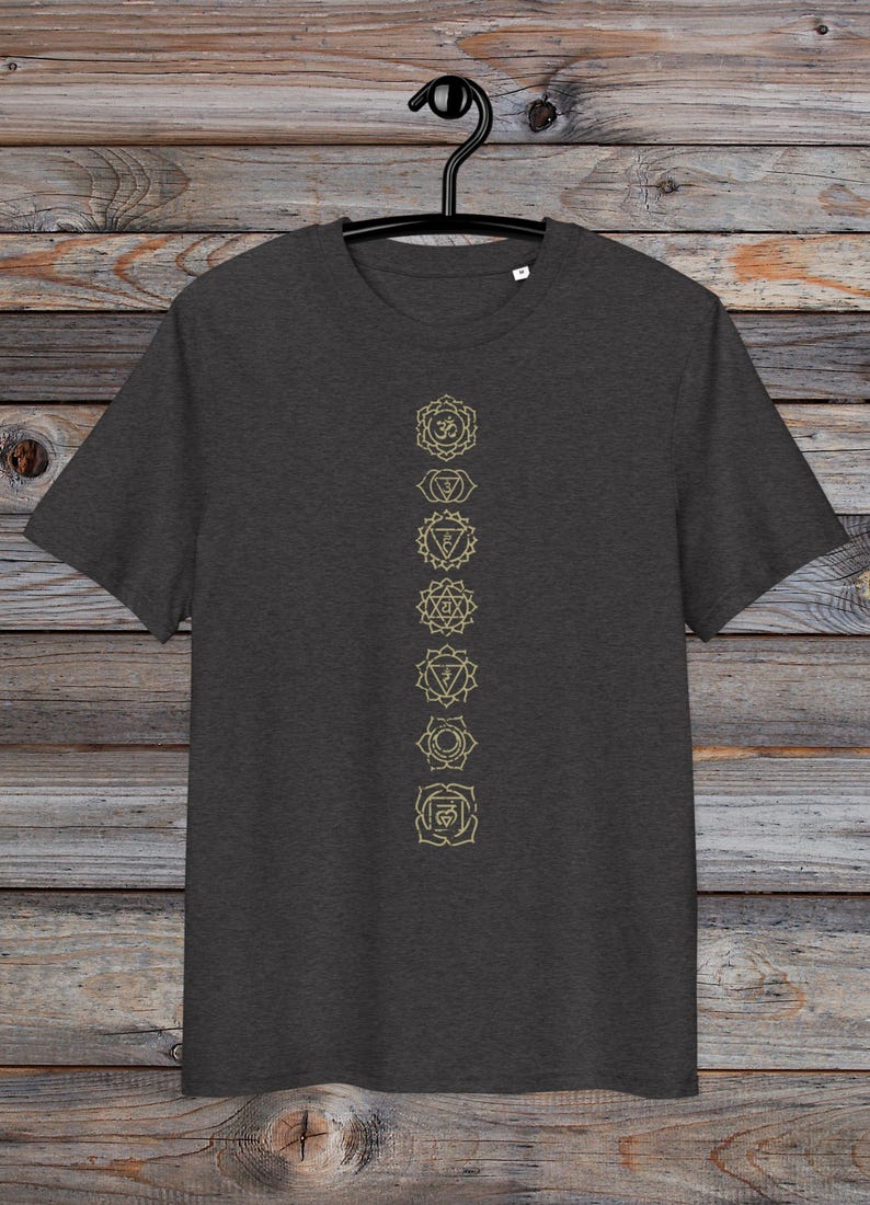 May include: A dark heather grey t-shirt with a vertical row of seven gold chakra symbols printed on the front. The symbols are in a line down the centre of the shirt.