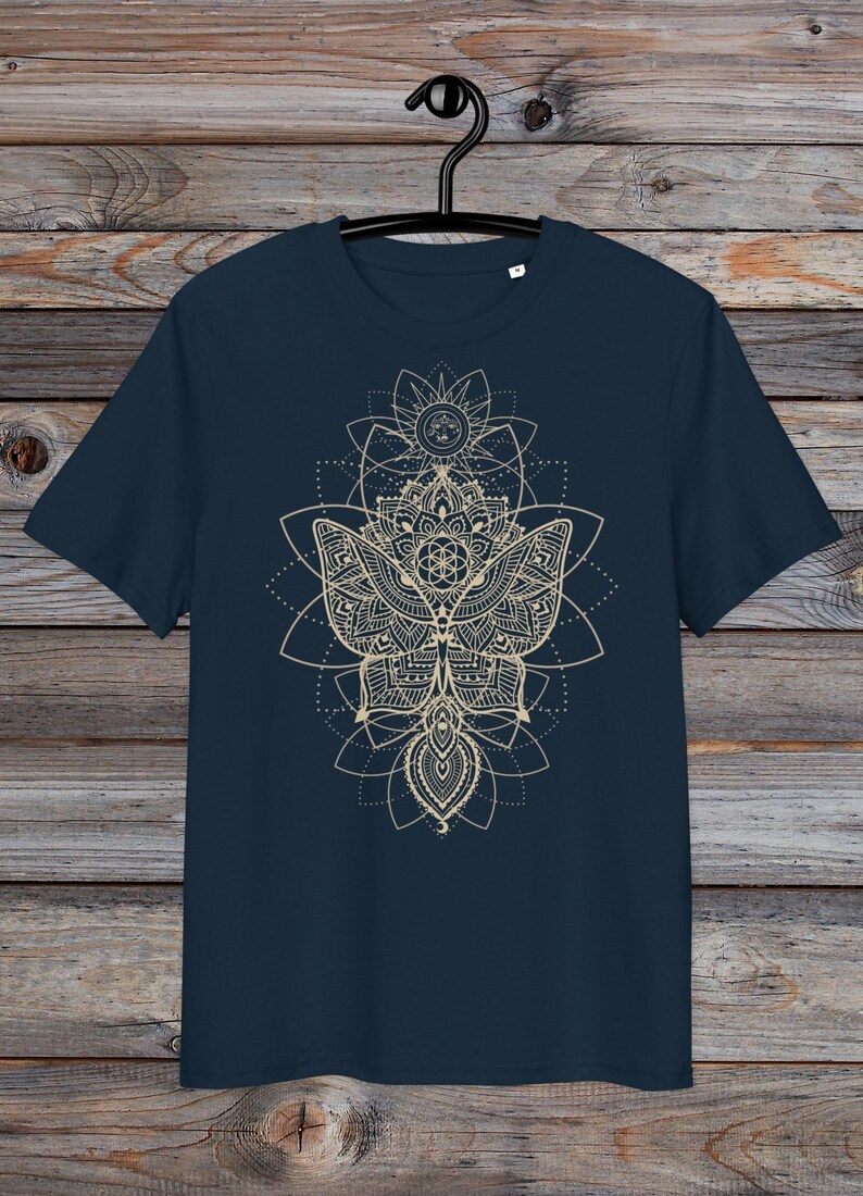 May include: A navy blue t-shirt with a gold mandala design featuring a butterfly and geometric patterns.