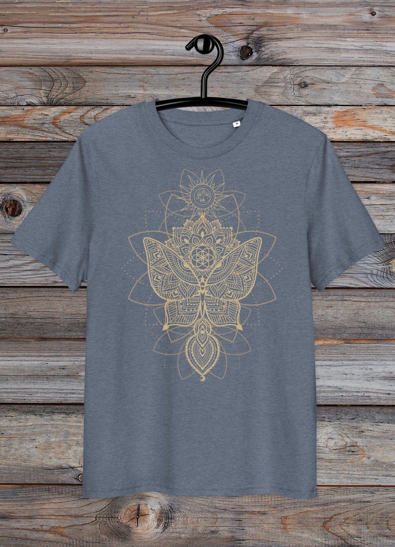May include: A heather grey t-shirt with a gold mandala design featuring a butterfly and geometric patterns.
