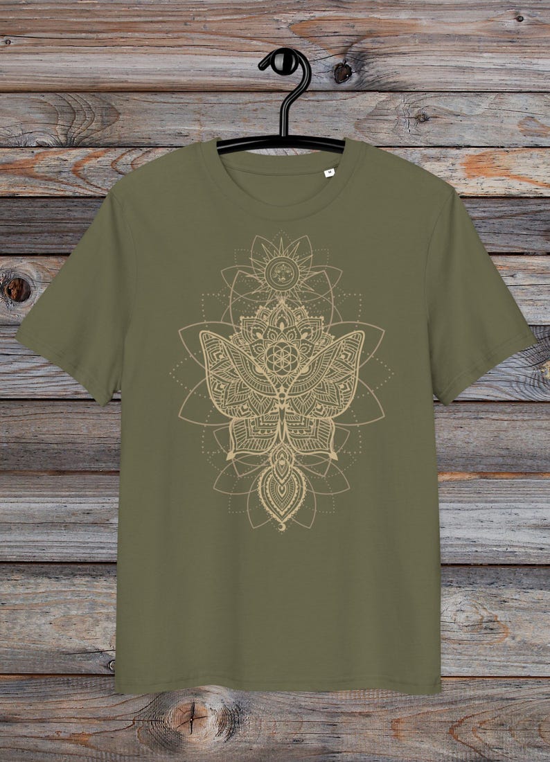 May include: A green t-shirt with a gold mandala design featuring a butterfly and geometric patterns.