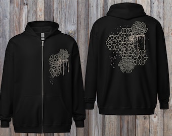 May include: Black zip-up hoodie with a geometric design on the front and back. The design features interconnected cubes and abstract shapes in a light tan color, with a distressed effect. The hoodie has a hood and a full-length zipper.