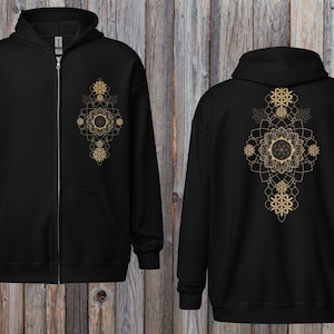 May include: Black zip-up hoodie featuring a gold geometric design on the front and back. The design includes floral and snowflake-like patterns. The hoodie has a hood, a full-length zipper, and a kangaroo pocket.