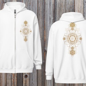May include: White zip-up hoodie with a gold geometric mandala design on the front and back. The hoodie has a hood, a full-length zipper, and two front pockets. The design is symmetrical and features intricate patterns.