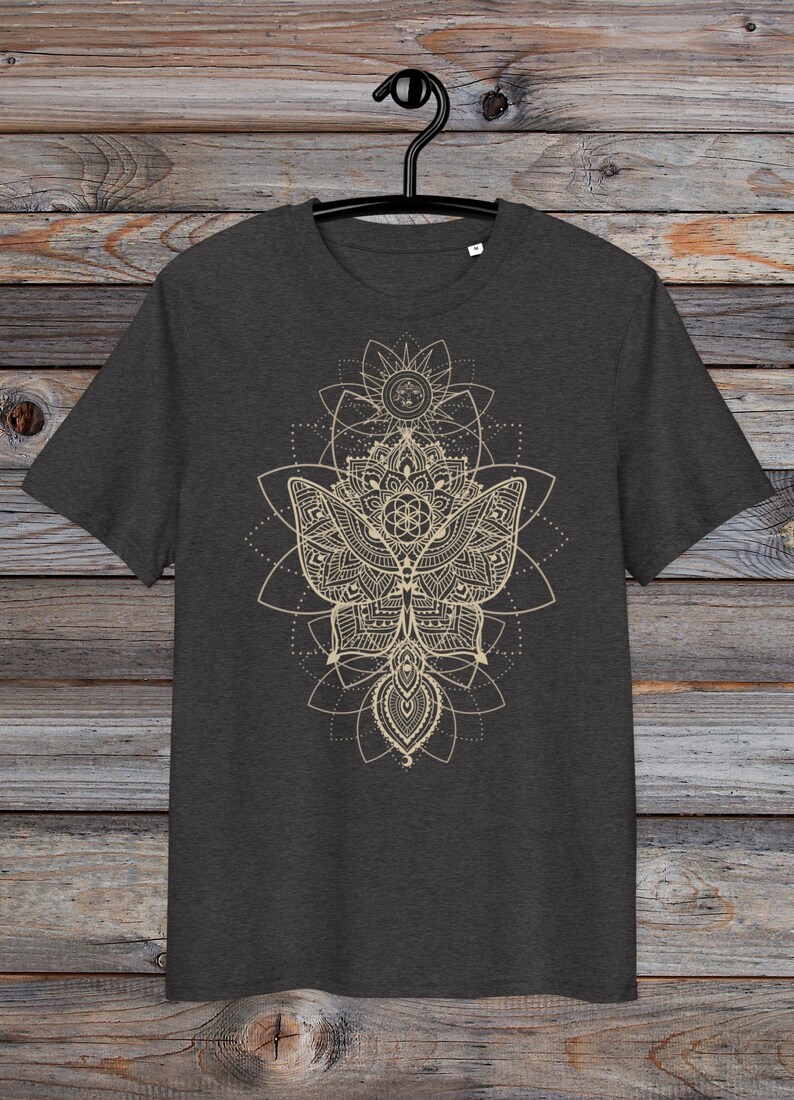 May include: A dark heather grey t-shirt with a gold mandala design featuring a butterfly and geometric patterns.