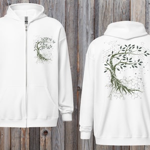 May include: White zip-up hoodie featuring a green and gray tree design on the front and back. The tree graphic has a detailed root system and leafy branches. The hoodie has a hood and front pockets.
