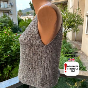 Back view of grey sparkly crochet top with deep V-neck design and thin straps, created from coastal grandmother blouse pattern PDF for summer festival fashion.