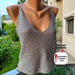 Detailed front view of sparkly grey crochet tank top with V-stitch mesh design and plunging neckline, made from beginner-friendly PDF crochet pattern for festival wear.