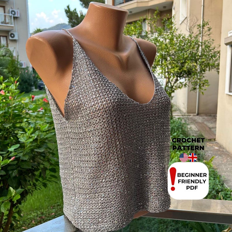 Mannequin displaying grey sequined mesh summer blouse with deep V-neckline and sparkly texture, created from intermediate crochet pattern PDF for coastal style.