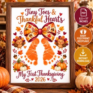 May include: A framed print featuring the text Tiny Toes & Thankful Hearts and My First Thanksgiving 2026. The design includes a large autumn-themed bow, two orange baby footprints, cartoon turkeys, pumpkins, acorns, and leaves on a white background.