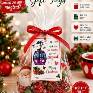 May include: A clear plastic bag filled with holiday treats, tied with a red ribbon and a rectangular gift tag. The tag features a purple gondola, holly, and text reading Thank you for making our visit magical and Merry Christmas.