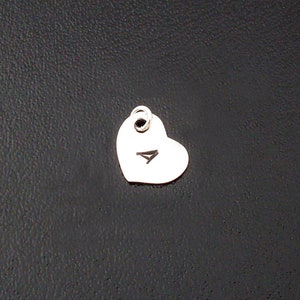 May include: A silver heart charm with the letter A engraved on it.
