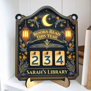 May include: A decorative wooden book counter with a dark blue background, gold accents, and the text "BOOKS READ THIS YEAR." The counter displays the number 234. The bottom reads "SARAH'S LIBRARY."