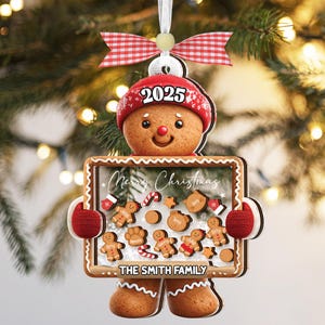 May include: Gingerbread man Christmas ornament with a red hat and mittens. The ornament holds a sign that says "Merry Christmas" and "The Smith Family". Includes gingerbread men, candy canes, and stars.