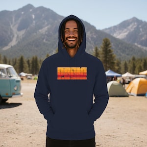 May include: A white hooded sweatshirt featuring a distressed, horizontal gradient graphic in shades of orange, red, and yellow. The text "PANIC" is printed in large, bold letters above the smaller text "GOT MONEY & GOOD MONEY" in a matching font.
