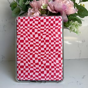 May include: A clear phone case with a red and white checkered pattern. The pattern is wavy and abstract.