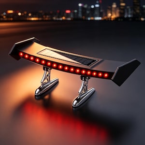 May include: A black solar-powered car spoiler with a row of red LED lights. The spoiler has a built-in solar panel and is supported by two chrome-colored stands. The background features a blurred cityscape at night.