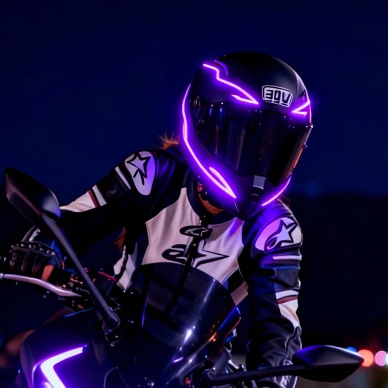 May include: A black motorcycle helmet with glowing purple accents. The helmet has a dark visor and the AGV logo. The rider is wearing a black and white motorcycle jacket with star-shaped patches. The image is taken at night.