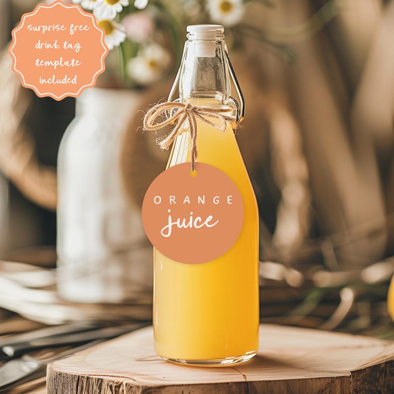 Puede incluir: Una botella de vidrio transparente llena de jugo de naranja, con cierre de tapa abatible y una etiqueta redonda naranja que dice "ORANGE juice". La botella est&aacute; atada con hilo y se encuentra sobre una superficie de madera. Una etiqueta dice "surprise free drink tag template included".