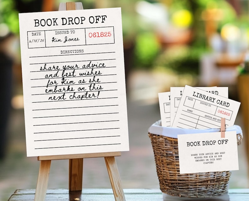 May include: A white sign on a wooden easel with the text "BOOK DROP OFF" and handwritten directions. A basket with library cards and a sign is next to the easel. The text reads, "share your advice and best wishes for Kim as she embarks on this next chapter!"