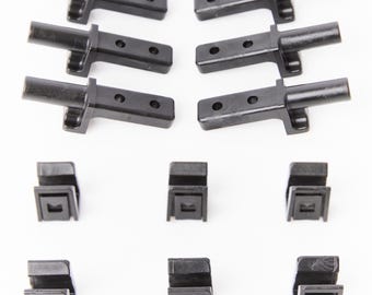 May include: A set of black plastic cabinet door hinges with a total of six hinges and six clips. The hinges have a small arm that extends out from the main body of the hinge.