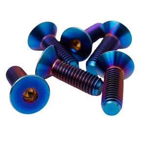 May include: A collection of six titanium bolts with a vibrant blue and purple iridescent finish. Each bolt features a flat head with a hexagonal socket and threaded shaft, ideal for mechanical or decorative applications.