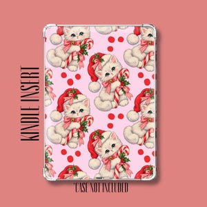 May include: A rectangular Kindle insert featuring a repeating pattern of white kittens wearing red Santa hats and holding candy canes against a light pink background with red dots. The text KINDLE INSERT and CASE NOT INCLUDED is visible.