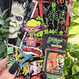 May include: A rectangular card featuring a collage of horror-themed comic book illustrations. The design includes Frankenstein's monster, a clown in a jack-in-the-box, a woman in a witch hat, and a figure holding a drink labeled Creeps Book No.